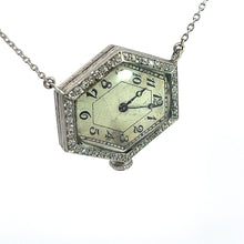 Load image into Gallery viewer, An Art Deco Platinum Pentagon Shape Watch featuring a white face, black numerals, and black hands is displayed. Evoking the elegance of the Art Deco era, this luxury timepiece is adorned with .88cttw diamonds set in an 18kt white gold case and attached to a delicate 20-inch silver chain.