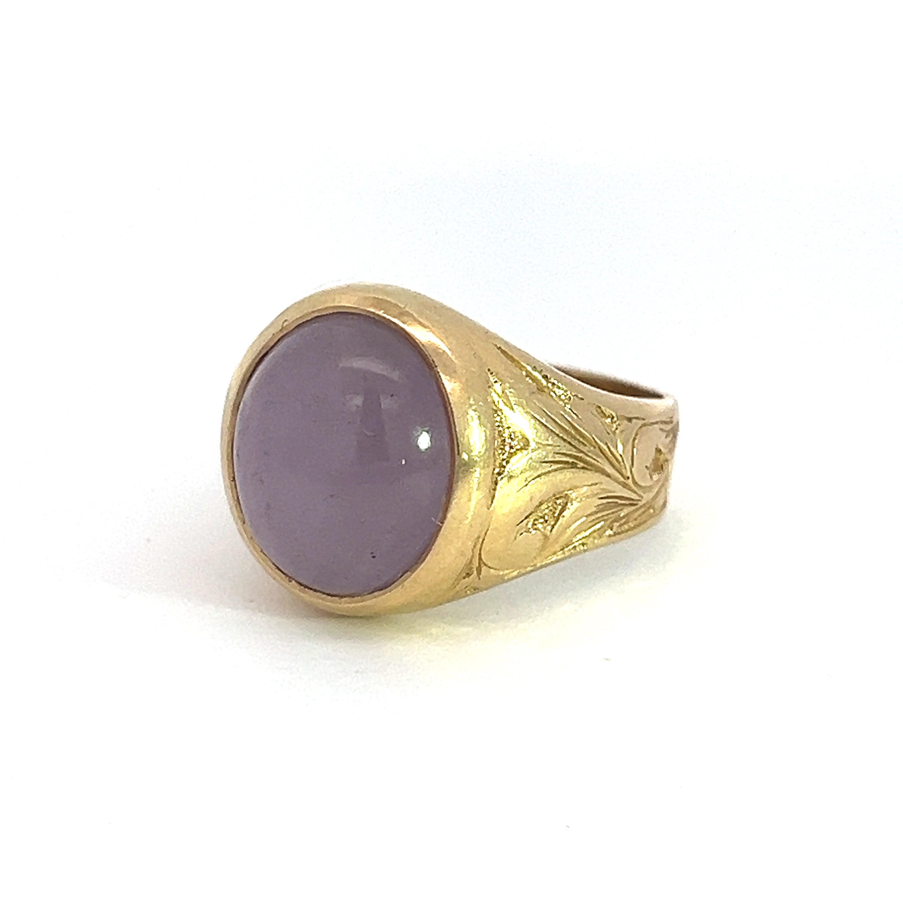 A Late 14kt yellow gold ring with detailed engravings on the band, featuring an approximately 8-carat polished lavender jade gemstone set in the center.