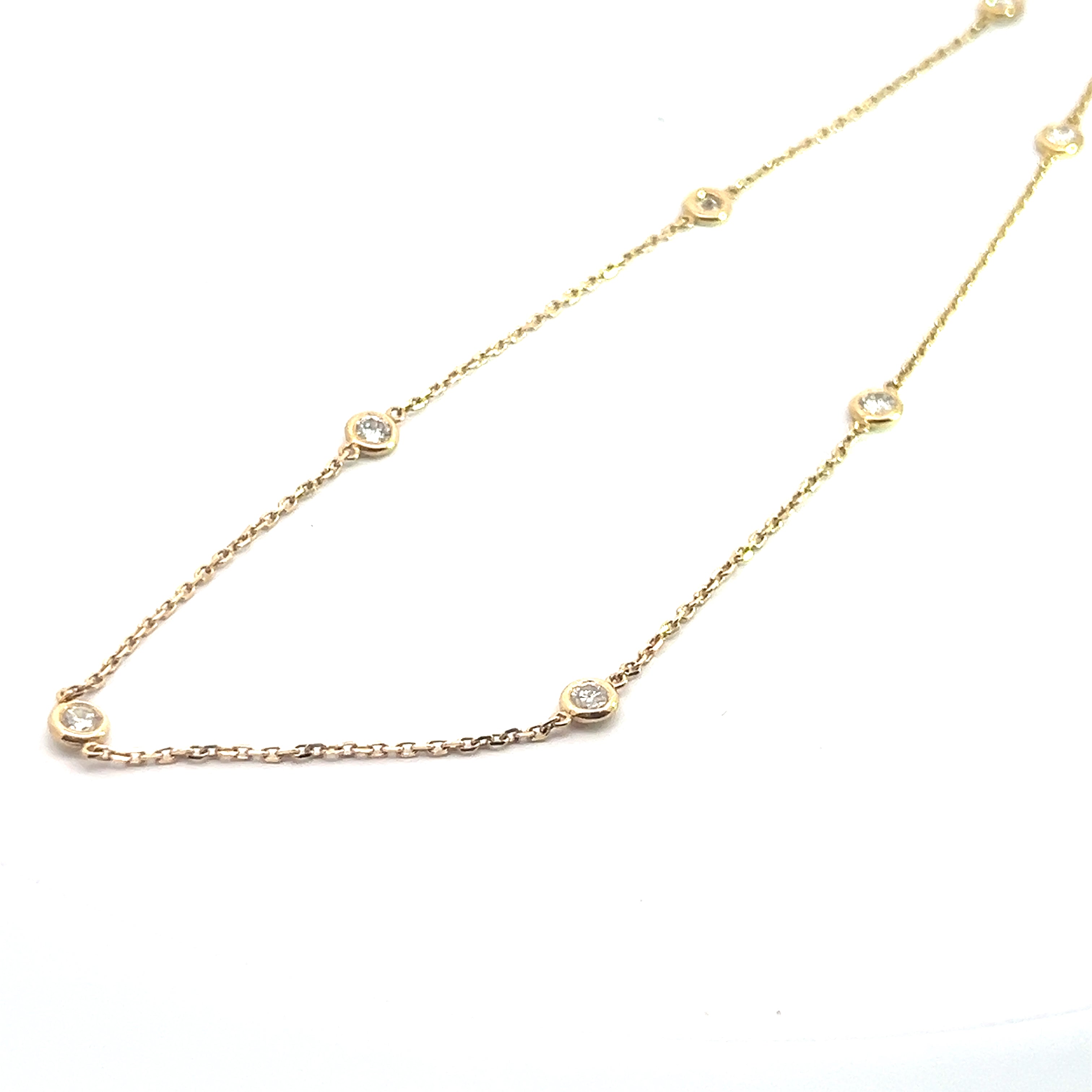 The Modern 14ktyg 1.03cttw 18 inch diamond collete showcases a gold chain adorned with evenly spaced small round diamond accents, each set in elegant bezel settings against a white background.