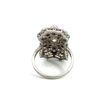 Load image into Gallery viewer, A platinum Art Deco ring, bearing a .93-carat Old European cut diamond and an additional 2.60 carats in total weight, showcases its large, ornate setting with intricate lace-like details and multiple small holes as it is viewed from the side against a plain white background.