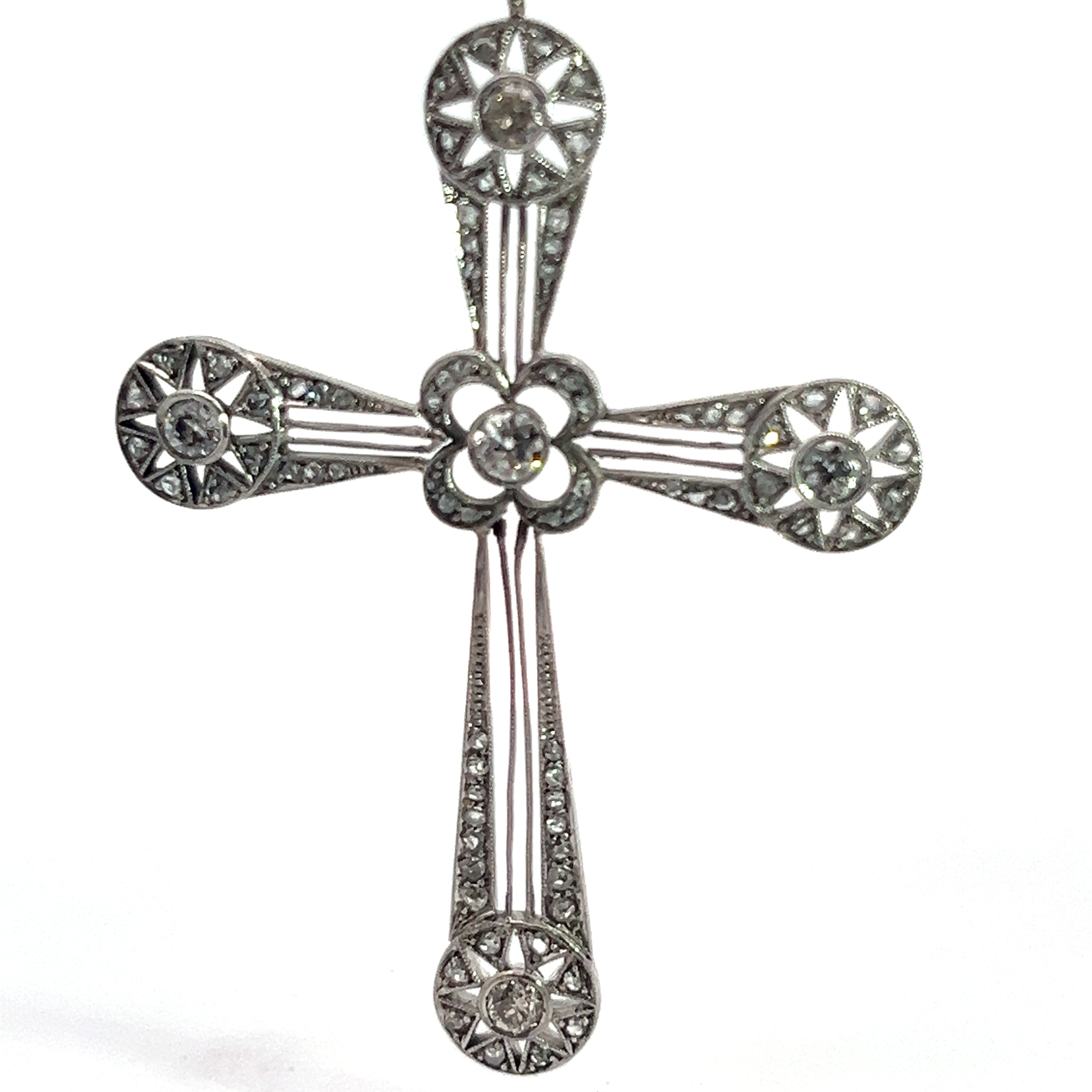 An exquisite Art Deco Platinum cross pendant adorned with intricate designs and set with 3.35ct Old European Cut and Rose Cut diamonds. The cross features circular floral patterns at the ends of each arm and in the center, interconnected by narrow, straight lines.