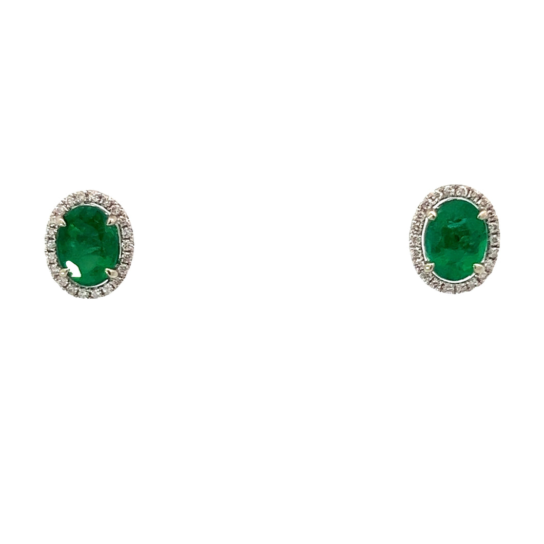 Introducing the Modern 14kt White Gold 4.72cttw Emerald + .44cttw Diamond Studs, these elegant earrings feature stunning oval-shaped green emerald gemstones totaling 4.72 carats. Each emerald is beautifully surrounded by a halo of small white diamonds, with a combined weight of 0.44 carats, all set against a plain white background. The design is simple yet sophisticated, flawlessly crafted in 14kt white gold.