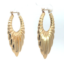 Load image into Gallery viewer, The Late Century 14kt Yellow Gold Textured Drop Earrings, featuring a ribbed design that mimics the appearance of shells, evoke a vintage charm. They are elegantly displayed hanging on a clear stand against a white background.