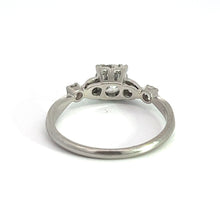 Load image into Gallery viewer, This exquisite Art Deco jewelry piece, the Platinum .50ct Old European Cut and .28cttw Old Mine Cut Diamond Ring, boasts an ornate setting with a raised design on the top. The polished platinum band curves into the detailed upper part, featuring intricate cutout patterns and small raised sections. Set against a plain white background, its elegance speaks volumes.