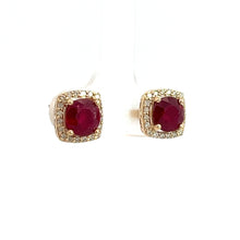 Load image into Gallery viewer, The Modern 14ktyg 2.43ct Vivid Red Rubies + .25cttw Diamond Stud Earrings each feature a square 14kt yellow gold setting adorned with small diamonds surrounding a large, round red ruby in the center, displayed on a simple white background. These pieces exemplify luxury jewelry at its finest.