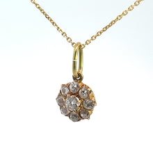 Load image into Gallery viewer, A Victorian 14kt yellow gold necklace with a 1.16 cttw Old Mine Cut Diamond Pendant in the shape of a flower, featuring several small, clear gemstones arranged in a circular pattern, hangs against a white background. The chain is delicate and lightweight.