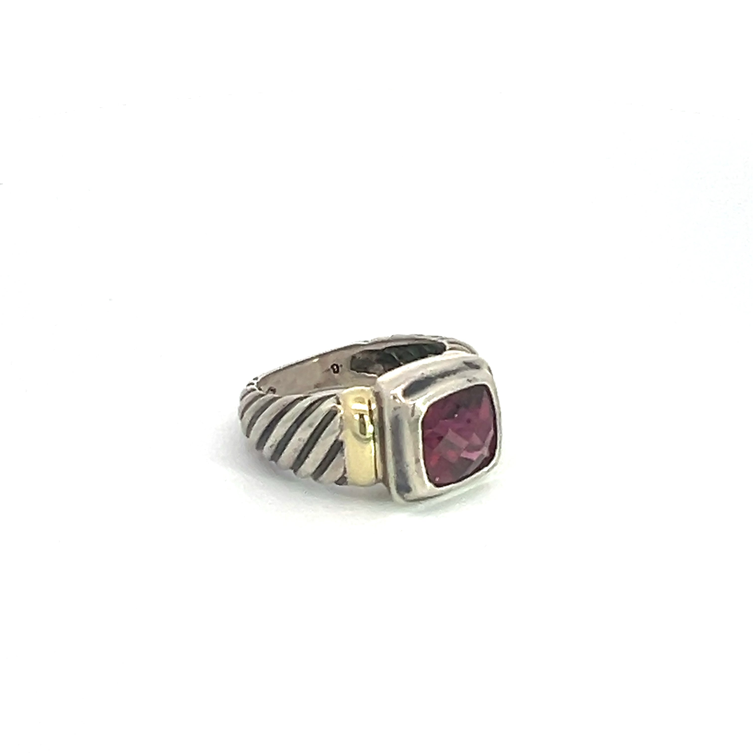 The Late Century 14ktyg/silver David Yermen 2.50ct Garnet Ring features a wide band with a grooved design made of sterling silver. At its center, it showcases a square, deep pink garnet gemstone, beautifully framed by a smooth, 14kt yellow gold bezel setting that offers a striking contrast against the silver band.