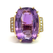 Load image into Gallery viewer, The Late Century 14kt yellow gold ring showcases a striking 33-carat rectangular-cut amethyst with softened corners. This magnificent centerpiece is flanked on either side by sections embellished with rows of small white diamonds totaling .70 carats. The exquisite diamond and amethyst ring is beautifully set against a plain white background.