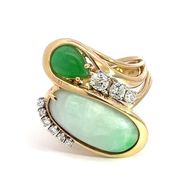 The Late Century 14kt Yellow Gold Jade + .60cttw Diamond Cocktail Ring showcases two striking jade stones—one pear-shaped and one oval—complemented by small, round diamonds elegantly set around the larger stone. An intricately twisted band adds a touch of sophistication to this beautifully designed piece.