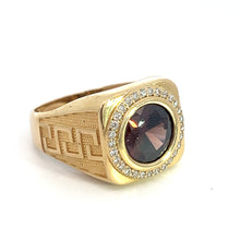 Load image into Gallery viewer, The Late Century 14kt yellow gold ring boasts a striking 4.5-carat garnet gemstone set prominently at its center, flanked by .75 total carat weight of small diamonds. The band features intricate geometric engravings, showcasing a late-century design that enhances its sophisticated allure. This elegant piece is displayed against a plain white background.