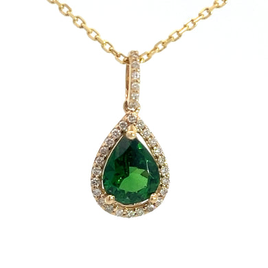 The Modern 14kt yellow gold necklace showcases a stunning 1.38ct teardrop-shaped green tsavorite garnet pendant, elegantly framed with .25cttw of small diamonds. The chain features a simple, classic design against a plain white background, adding an elegant sparkle to any ensemble.