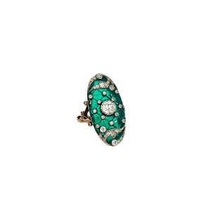 A stunning Art Deco Platinum & 18kt Yellow Gold ring featuring a .75ct old mine cut diamond surrounded by 1.90cttw of smaller diamonds, all set against a vibrant green enamel background with intricate white patterns. The diamond and enamel detailing along the band provide an ornate touch to this exquisite piece.