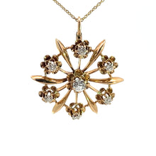 Load image into Gallery viewer, The Victorian 14ktyg .80cttw old mine cut diamond pendant is a stunning necklace crafted from 14kt yellow gold, featuring a floral design with seven old mine cut diamonds arranged in a circular pattern. The central stone is larger and surrounded by six smaller stones, each set within a delicate gold flower. Reflecting the elegance of the Victorian era, the chain is composed of thin, delicate gold links.