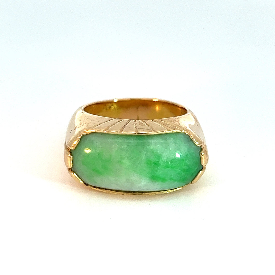 Introducing the Mid Century 18kt Yellow Gold Marbled Jade Saddle Ring: This elegant piece showcases a large, rectangular marbled jade stone set on a white background. The jade exhibits stunning light and dark hues, enhancing its aesthetic appeal. Complementing the stone, the gold band features a wide, smooth design with subtle engravings near the setting.