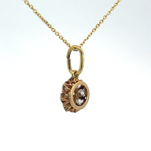 Load image into Gallery viewer, A delicate Victorian 14kt yellow gold necklace with a 1.16cttw old mine cut diamond pendant, featuring two small, sparkling diamonds set in a circular gold setting with intricate details. The thin, elegant chain complements the overall design beautifully.