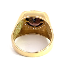 Load image into Gallery viewer, A Late Century 14ktyg ring with a broad band and an inset gemstone, viewed from the side of the band showing the inside. The interior is finely textured, creating a contrast with the smooth outer surface. The 14kt yellow gold ring features a 4.5ct garnet and .75cttw of diamonds positioned at the top but not fully visible from this angle.