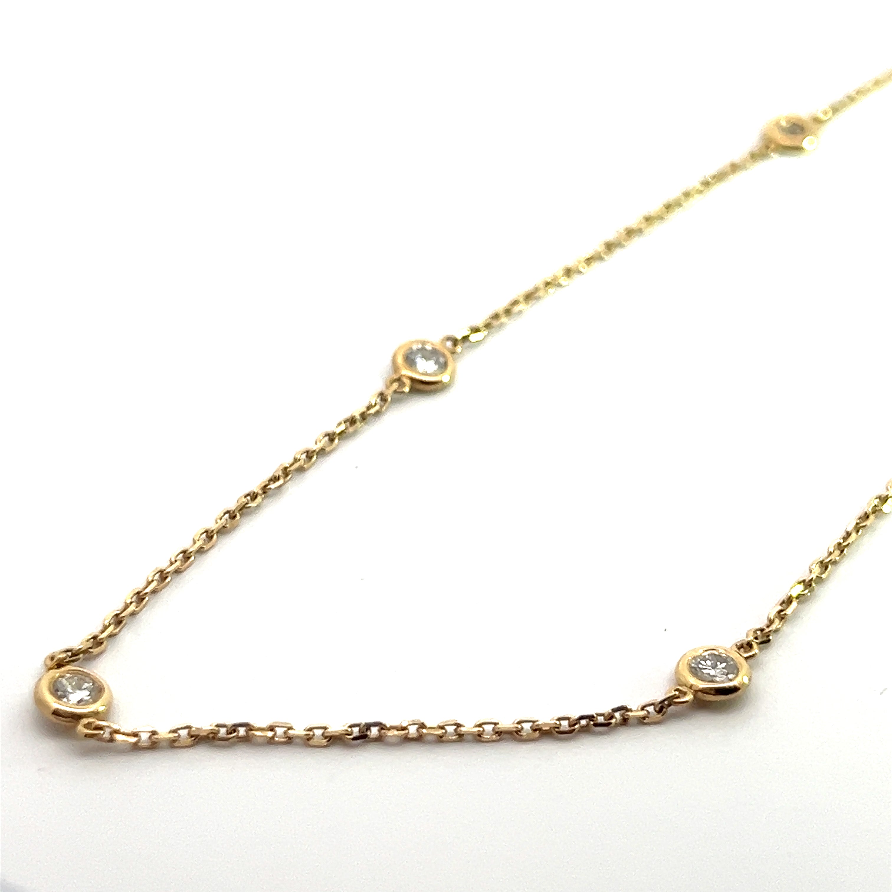 The Modern 14ktyg 1.03cttw 18 inch diamond collete showcases a gold chain adorned with evenly spaced small round diamond accents, each set in elegant bezel settings against a white background.