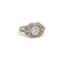 Load image into Gallery viewer, The Late Art Deco Platinum .91ct Round Brilliant Cut Diamond + 1.16cttw Diamond Ring exudes Art Deco elegance, featuring a central round brilliant cut diamond set in an ornate octagonal bezel. The ring is adorned with intricate detailing and vintage sophistication, accented by smaller surrounding diamonds on the band and bezel.