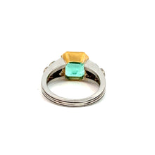 Load image into Gallery viewer, Product: The Mid Century Platinum &amp; 18kt Yellow Gold ring features a stunning twin-stone setting with a 4.03ct emerald cut emerald next to .70cttw diamonds, exuding sophistication and elegance. Its smooth and elegant band enhances the classic allure of the gemstones against a plain white background.