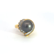 Load image into Gallery viewer, The Mid Century 14ktyg Black Pearl + 1.25ct diamond ring features a large black pearl at its center, elegantly surrounded by a semi-circle of small round diamonds on one side and rectangular diamond baguettes on the other, boasting a sleek and intricate design.