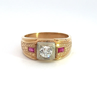 Introducing an exquisite Art Deco 14k yellow gold ring, featuring a .60-carat Old European Cut diamond at its center, flanked by two rectangular synthetic rubies. The ring's polished finish and intricate detailing exemplify a perfect blend of elegance and craftsmanship.