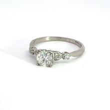 Load image into Gallery viewer, The Art Deco Platinum ring boasts a .50-carat Old European Cut diamond at its center, flanked by two smaller Old Mine Cut diamonds totaling .28 carats. This vintage-inspired engagement ring is set on a slender band and displayed against a white background.