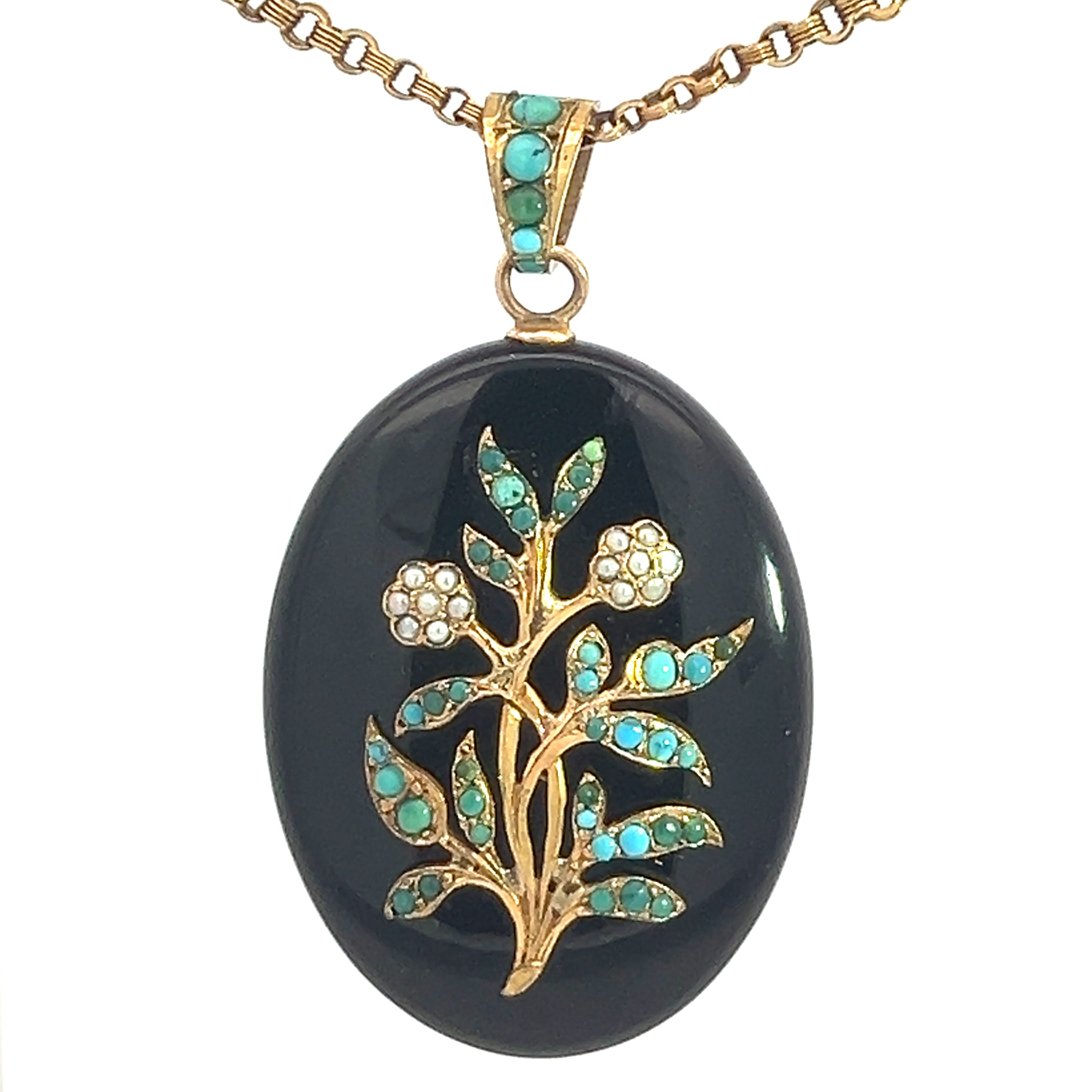 The Victorian 14ktyg Turquoise + Pearl locket on a Victorian chain is an elegant oval-shaped black locket adorned with a gold floral design. It features delicate turquoise stones in the leaves and pearl-like stones in the flowers, all hanging from a 14kt yellow gold chain.