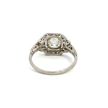 Load image into Gallery viewer, The Late Art Deco Platinum .91ct Round Brilliant Cut Diamond + 1.16cttw Diamond Ring, featuring a large central gemstone and intricate filigree design, is displayed on a plain white background. This ring showcases vintage sophistication and detailed craftsmanship with its delicate patterns and Art Deco elegance.