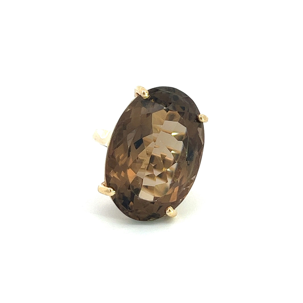 Presenting the Late Century 14kt yg approx 12ct smokey topaz ring, a stunning piece featuring an oval-shaped, faceted smoky quartz gemstone set in four prongs. The stone exhibits a rich brown color that captures late-century glamour against a plain white background.