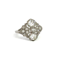 Load image into Gallery viewer, The Art Deco Platinum 1.20cttw Old Mine Cut + 1.04cttw Diamond Ring features an ornate design with three prominent hexagonal diamonds arranged vertically at the center, flanked by smaller Old Mine cut diamonds in an intricate pattern. This stunning piece is set in platinum and photographed against a plain white background.