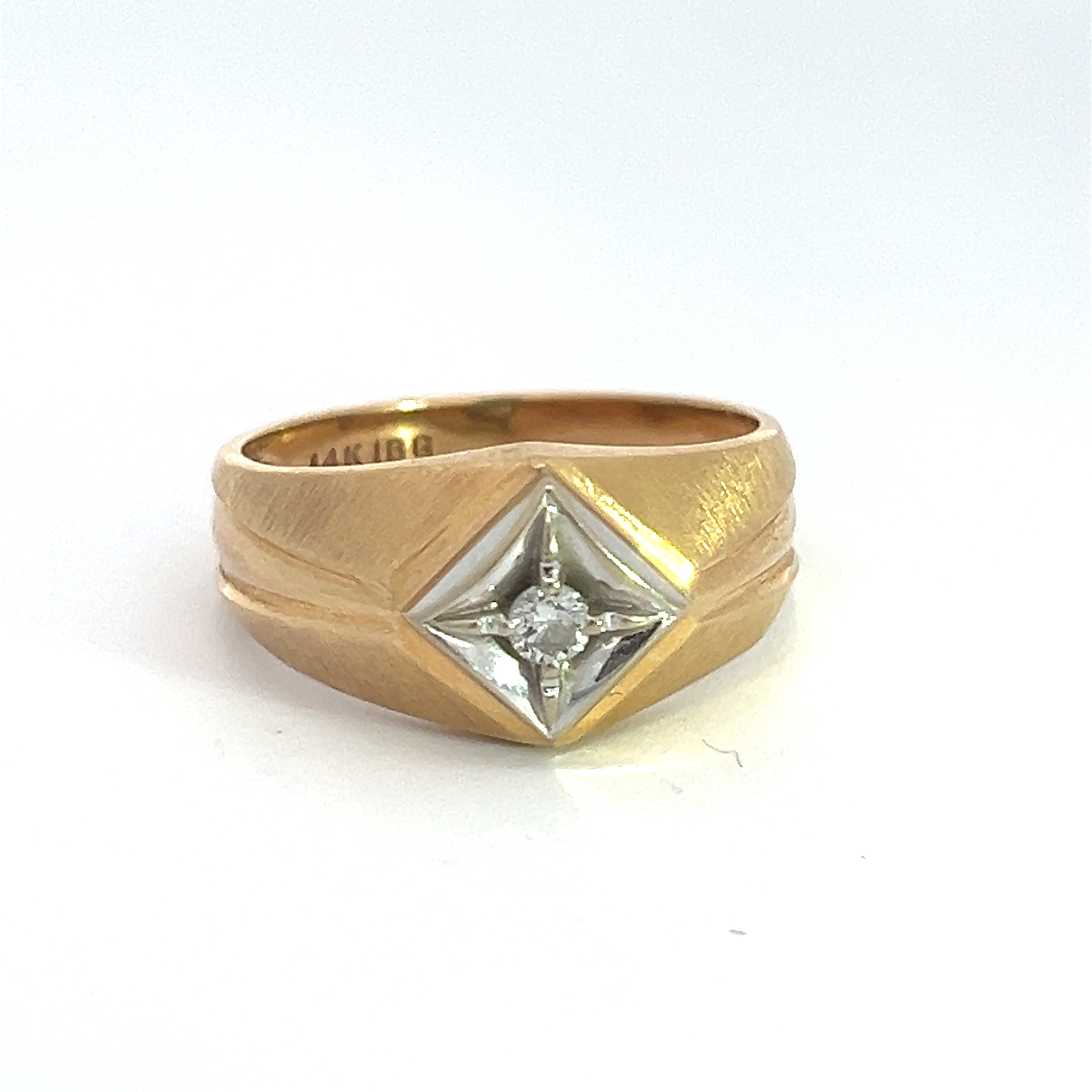 The Late Century 14ktyg .15ct Round Brilliant Cut Diamond Ring features a square-shaped setting showcasing a round brilliant cut diamond at its center. Its gold band boasts a matte finish accentuated by subtly indented diagonal lines on each side of the setting.