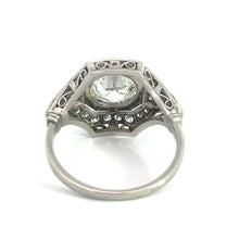 Load image into Gallery viewer, The Art Deco Platinum 2ct Old European Cut Diamond + .84cttw Diamond Ring features an ornate, intricate filigree design on the sides, showcasing a large, round-cut gemstone set atop it. This ring&#39;s detailed craftsmanship includes small decorative accents beneath the main stone. The vintage diamond ring is displayed against a white background.