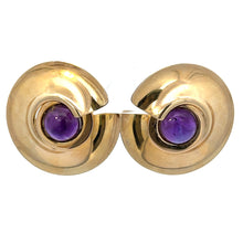 Load image into Gallery viewer, A pair of gold clip-on earrings with a spiraled design, each featuring a round, purple gemstone in the center. The earrings are shiny and smooth, reflecting light on their metallic surface. These Late Century Peter Wong 10ct Cabochon Amethyst Earrings showcase artistic craftsmanship and Late Century design at its finest.