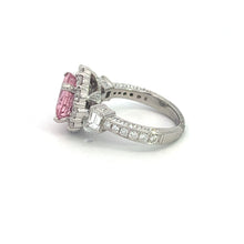 Load image into Gallery viewer, Introducing the Modern Platinum 3.30 No Heat Padparadscha Sapphire ring, featuring a striking no-heat Padparadscha sapphire at its center, surrounded by smaller white gemstones. The band is adorned with additional small gemstones along its sides, enhancing its intricate and elegant design with this rare gemstone.