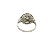 Load image into Gallery viewer, A late Art Deco silver ring, named the Late Art Deco .90ct Round Brilliant Cut Diamond + 1.96cttw Diamonds Black Enamel Ring, displays an ornate design with a central circular round brilliant cut diamond setting, viewed from the side. The thin band supports an intricate setting that elevates the gemstone, highlighted by detailed metalwork and black enamel reminiscent of vintage luxury. The background is plain white.