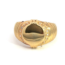 Load image into Gallery viewer, The Late Century 14ky Yellow Gold .24cttw Signet Ring showcases an oval-shaped central piece with a smooth, reflective surface. Surrounding the oval is a border of small, sparkling diamonds that enhance the ring&#39;s elegant and luxurious appearance. The band features polished, grooved lines that make it a perfect addition to any fine jewelry collection.