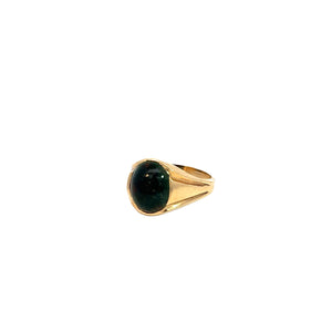 The Victorian 14kt Yellow Gold Bloodstone Ring showcases an oval, dark green gemstone set in the center. Displayed against a plain white background, the simple and sleek band enhances the vintage allure of the gemstone.