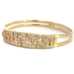 Introducing the Late Century 18ktyg 1.80cttw Greek Key Diamond Bangle Bracelet: a stunning gold bracelet featuring a geometric pattern of sparkling diamonds. This exquisite piece boasts a double band design, with the diamond-encrusted section on the front forming an elegant zigzag motif inspired by the traditional Greek key pattern. Presenting this breathtaking bracelet on a pristine white background enhances its captivating allure.
