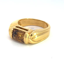 Load image into Gallery viewer, The Late Century 18ktyg 3ct Cognac Zircon ring is a vintage luxury piece featuring a rectangular 3-carat brown gemstone set in the center. It is crafted from 18kt yellow gold and has a smooth, polished band adorned with subtle, angular designs on either side of the gemstone. The ring is beautifully showcased against a plain white background.