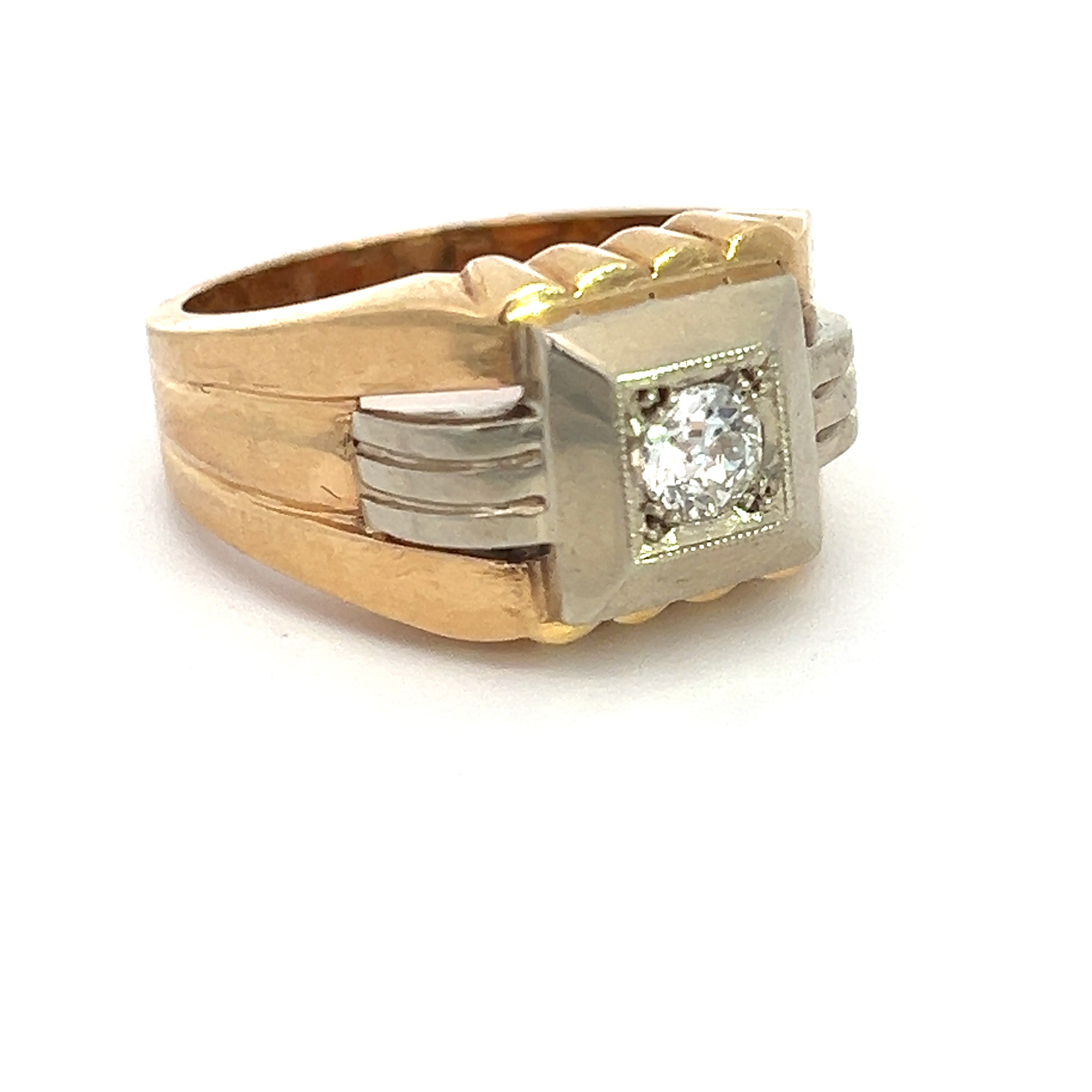 The Art Deco 14kt Two Tone Gold .40ct Old European Cut Diamond Ring showcases a square setting with a prominent old European cut diamond at its center. The ring features a slightly wide band adorned with ridged details on the sides, blending gold and silvery elements around the setting to create an elegant and classic appearance.