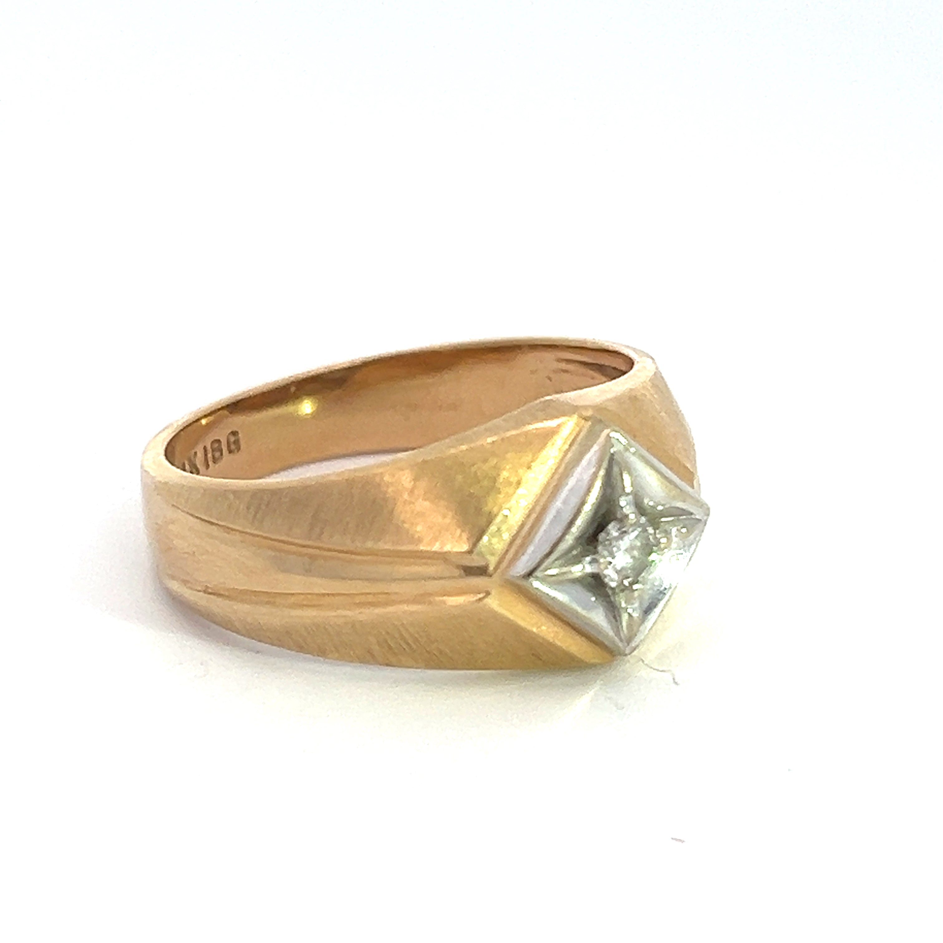 The Late Century 14ktyg .15ct Round Brilliant Cut Diamond Ring features a square-shaped setting showcasing a round brilliant cut diamond at its center. Its gold band boasts a matte finish accentuated by subtly indented diagonal lines on each side of the setting.