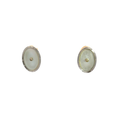 Against a plain white background, a pair of oval cufflinks with a light pearly center encased in a metallic border evoke the elegance found in Art Deco 14kt Yellow & White Gold Mother of Pearl Omega Back Earrings.