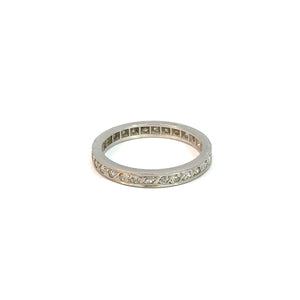 An Art Deco Platinum .50cttw Diamond Eternity Band with a band encrusted with small diamonds. The diamonds symbolize eternal love, set in a continuous row around the entire band. The ring is displayed against a plain white background.