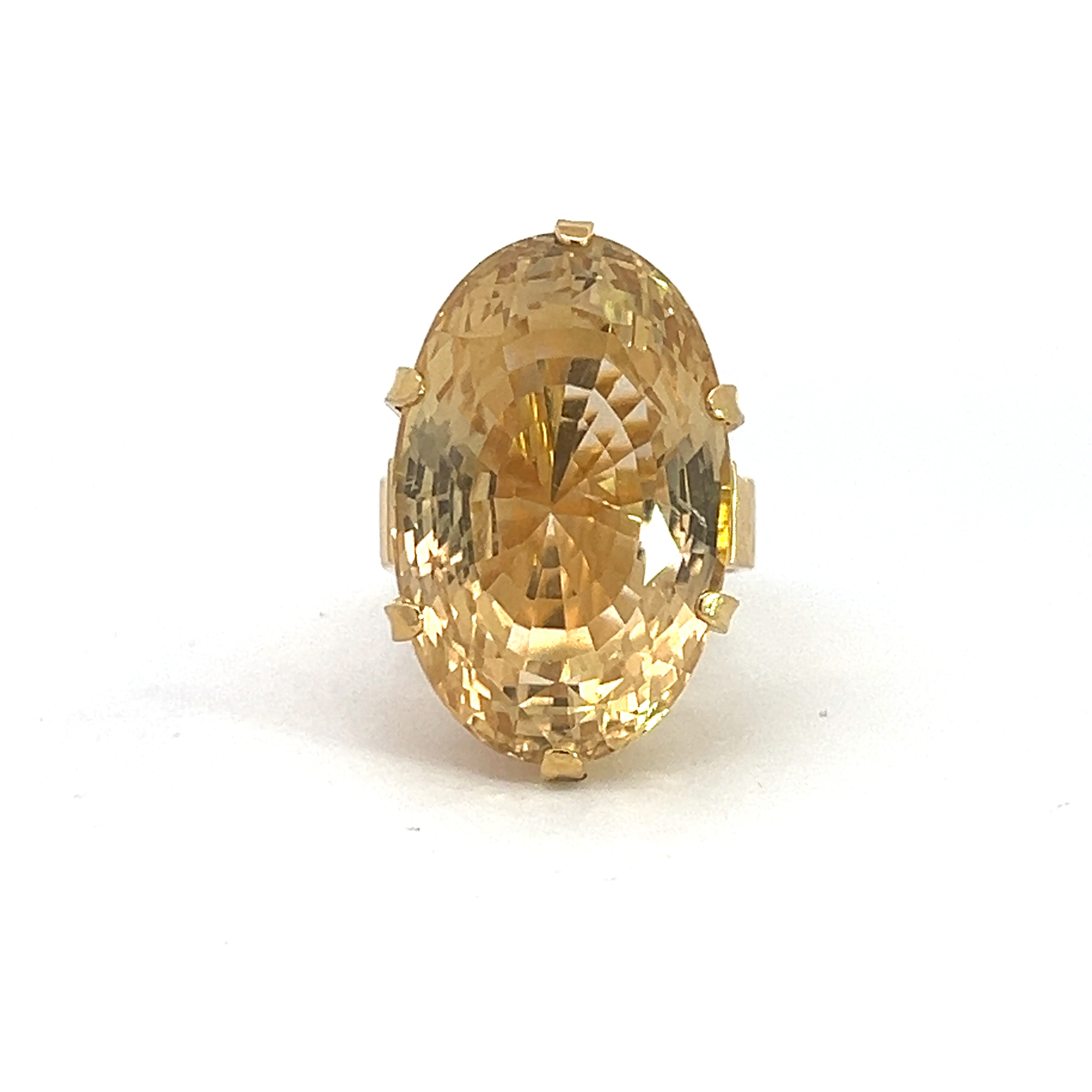 The Late Century 18ktyg 22ct Oval Citrine Ring features a gold oval-shaped band adorned with a large, faceted yellow citrine gemstone set in a six-prong setting. The intricate internal facets of the citrine catch and reflect light, creating a dazzling sparkling effect against the plain white background.
