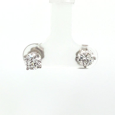 The Modern 14kt White Gold 1.41cttw Round Brilliant Cut Diamond Studs are elegantly showcased on a transparent holder against a white background. These exquisite diamond stud earrings feature round brilliant cut diamonds set in a classic four-prong setting, crafted in elegant 14kt white gold.