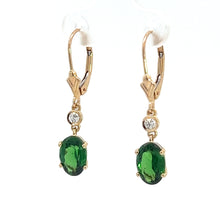 Load image into Gallery viewer, These earrings, named the &quot;Modern 14kt Yellow Gold 2.25ct Tsavorite Garnets + .10cttw Diamond Earrings,&quot; feature elegant drop designs with 14kt yellow gold hooks. Each earring showcases a small, round diamond set above a larger, oval-shaped Tsavorite Garnet. The gemstones are secured with prongs in a stylish gold setting.