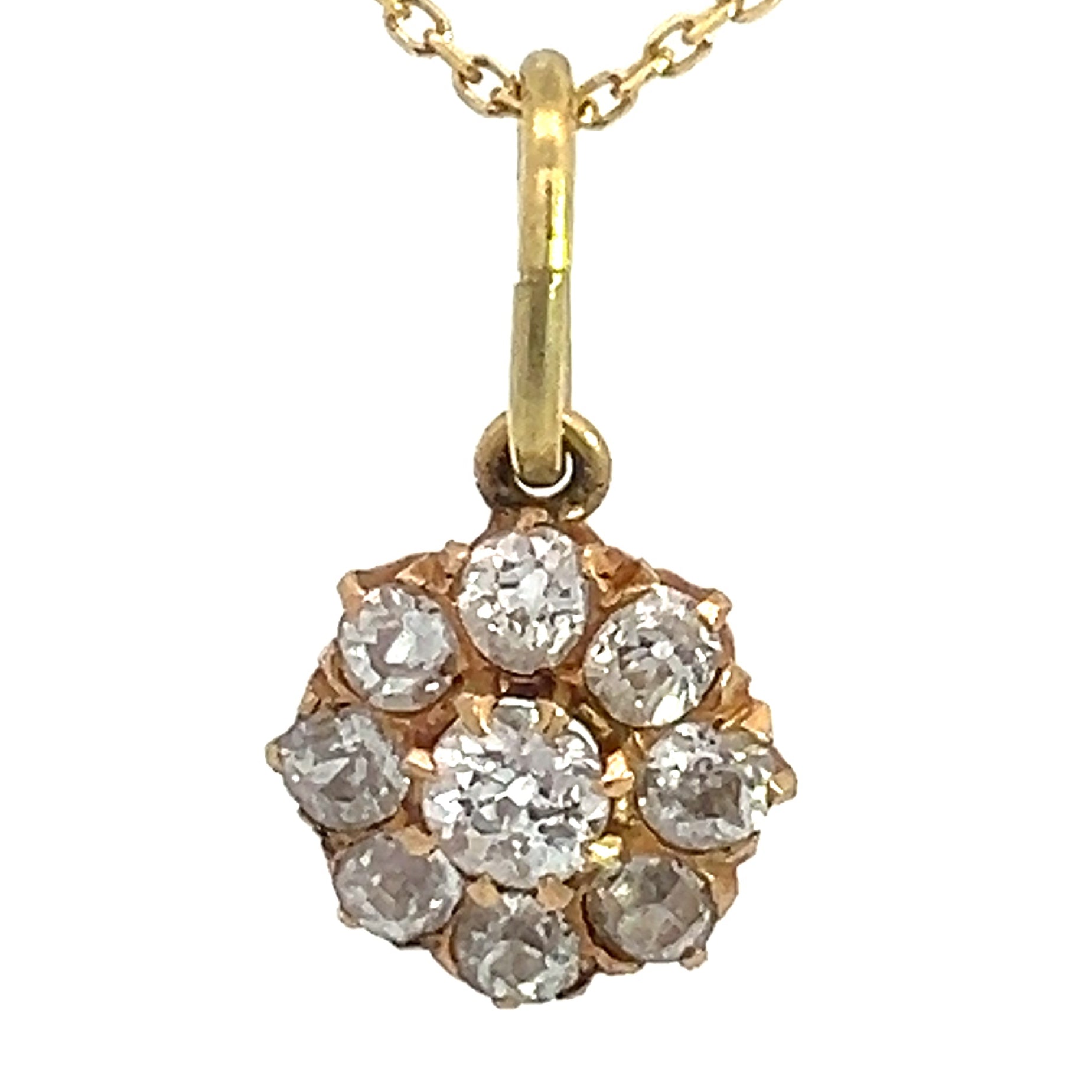 A Victorian 14kt yellow gold necklace showcasing a pendant adorned with a cluster of nine small, round old mine cut diamonds totaling 1.16 carats and arranged in a charming flower-like design. The timeless pendant is suspended elegantly from a delicate gold chain, all set against a white background.

