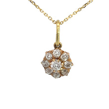 Load image into Gallery viewer, A Victorian 14kt yellow gold necklace showcasing a pendant adorned with a cluster of nine small, round old mine cut diamonds totaling 1.16 carats and arranged in a charming flower-like design. The timeless pendant is suspended elegantly from a delicate gold chain, all set against a white background.

