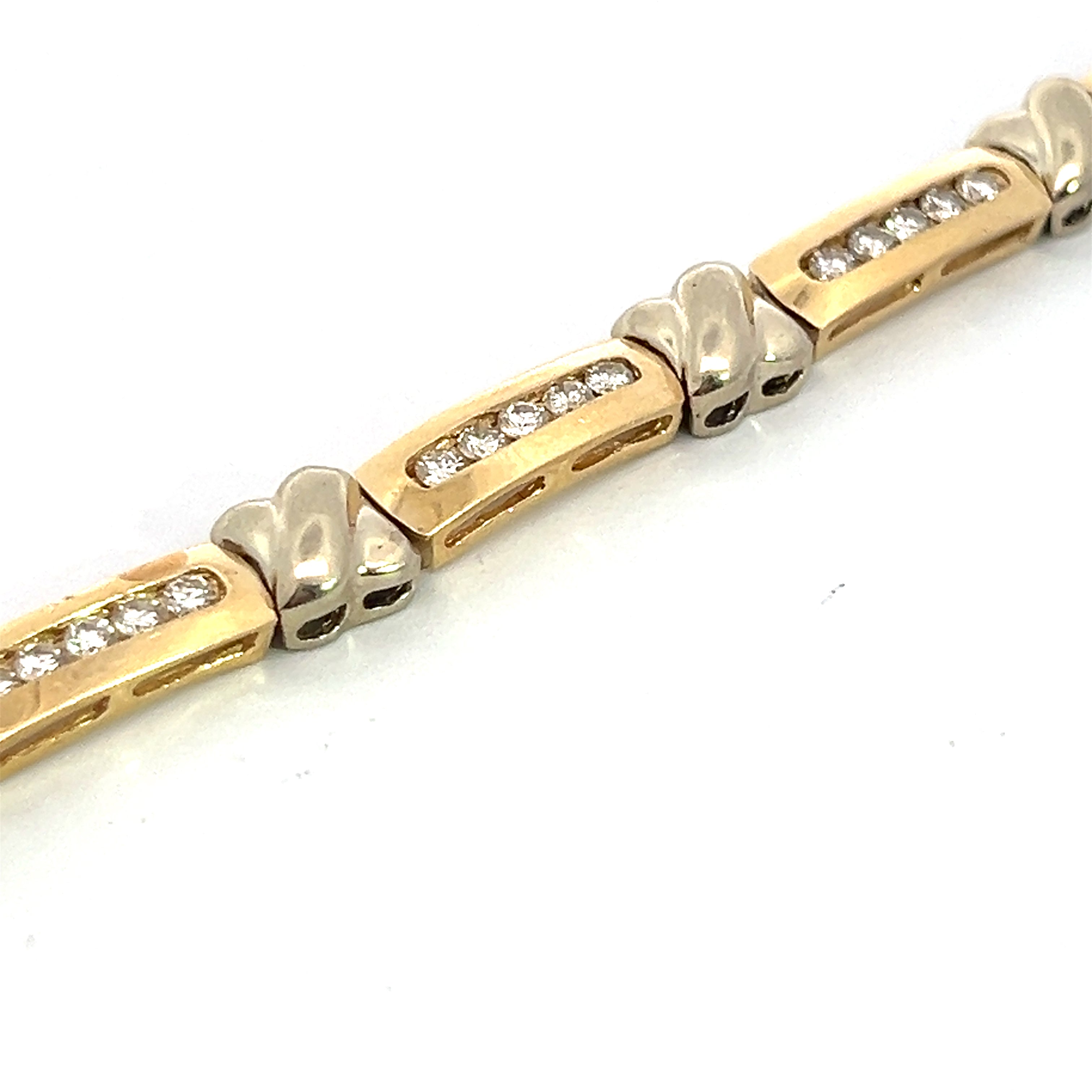 A close-up image of the "Late Century 14ktyg 3.08ct Round Brilliant Cut Diamond X Tennis Bracelet" reveals its intricate design, featuring rectangular gold links each adorned with a row of round brilliant cut diamonds. The silver connectors between the links boast a smooth, polished finish. The 7.5-inch bracelet is set against a white background.