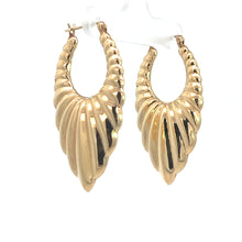 Load image into Gallery viewer, A pair of Late Century 14kt Yellow Gold Textured Drop Earrings designed with a twisted, shell-like pattern, hanging from a white display stand. These earrings feature a shiny, polished finish and an elegant, eye-catching design.